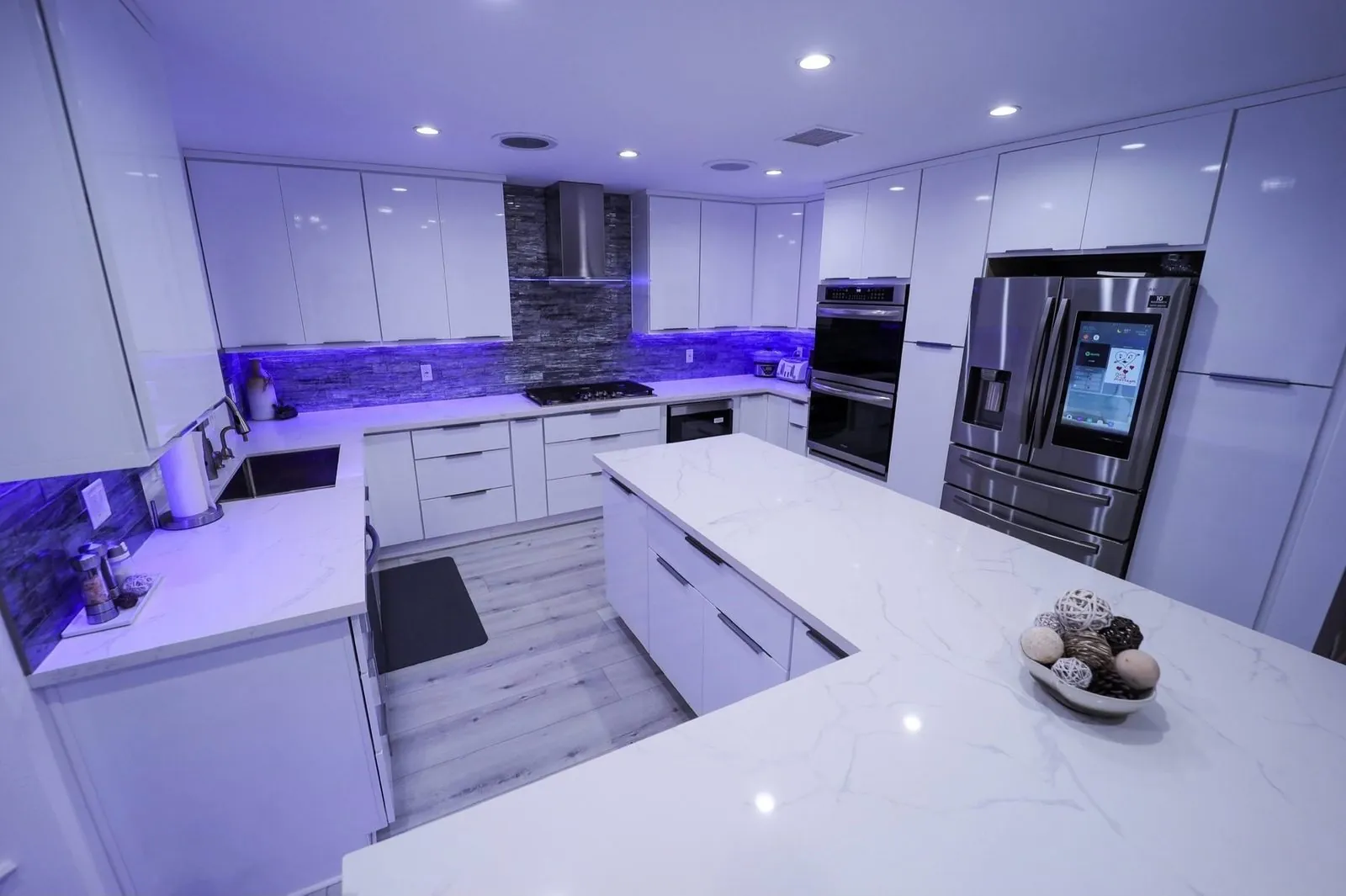 Open kitchen with Calacatta marble island and Samsung smart refrigerator